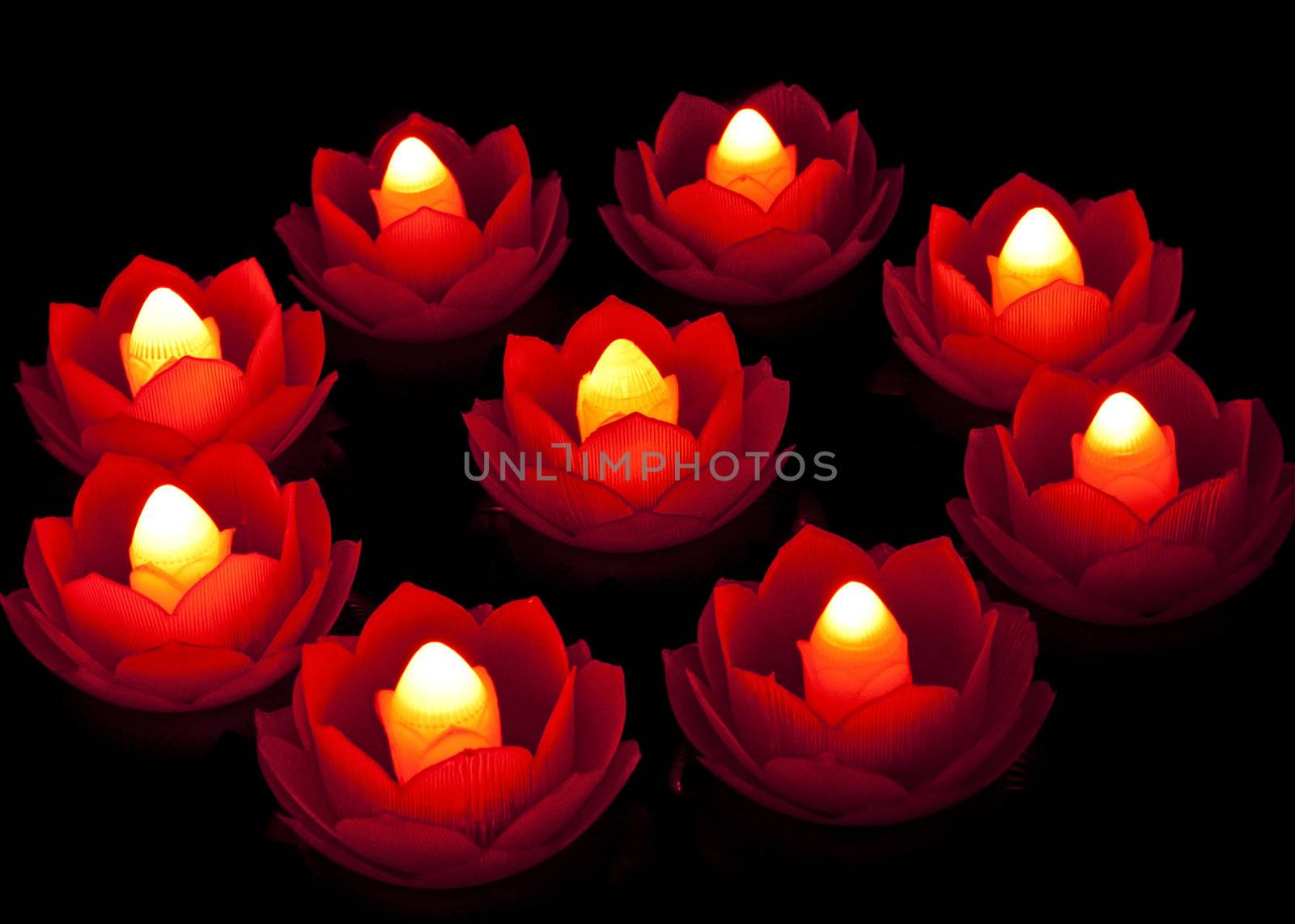 Lighting lotus lamp in dark is a symbol of wisdom overcoming ignorance.