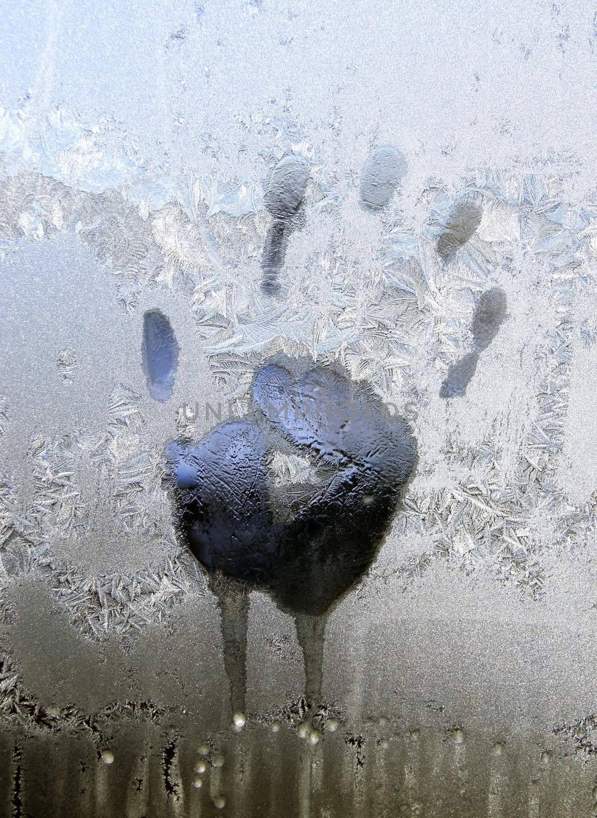 Handprint on ice window, sign desires spring