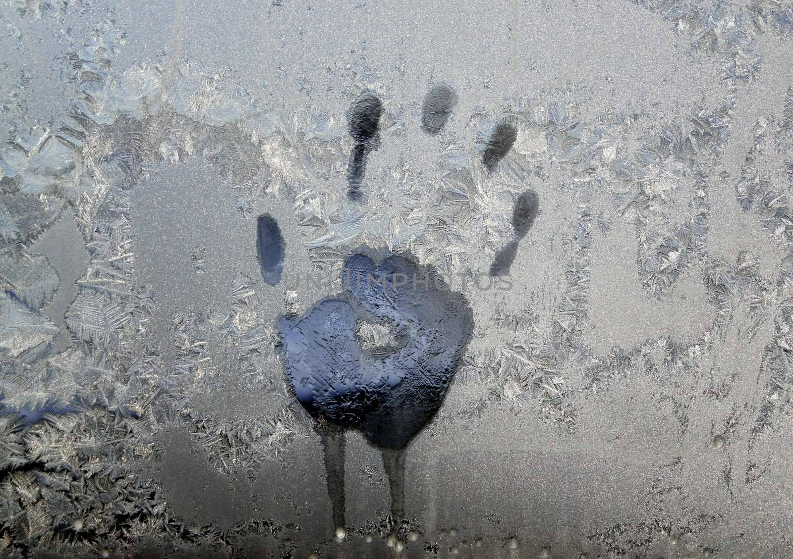 Handprint on ice window, sign desires spring