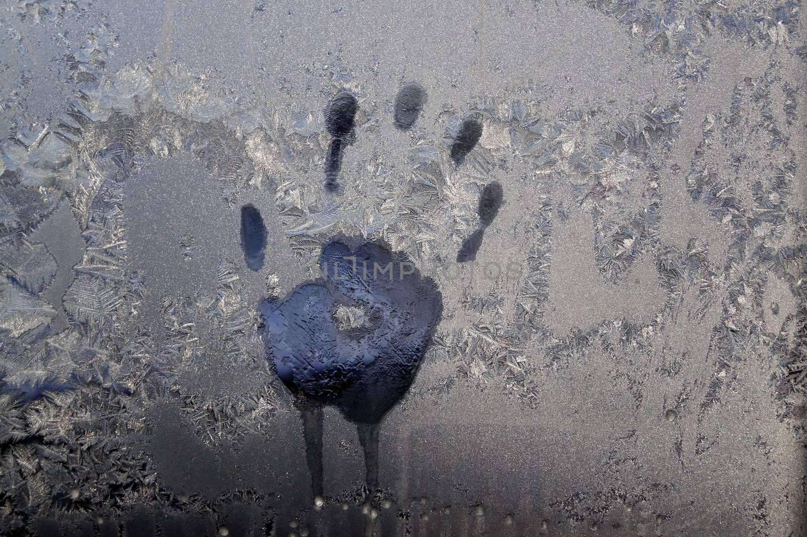 Handprint on ice window, sign desires spring