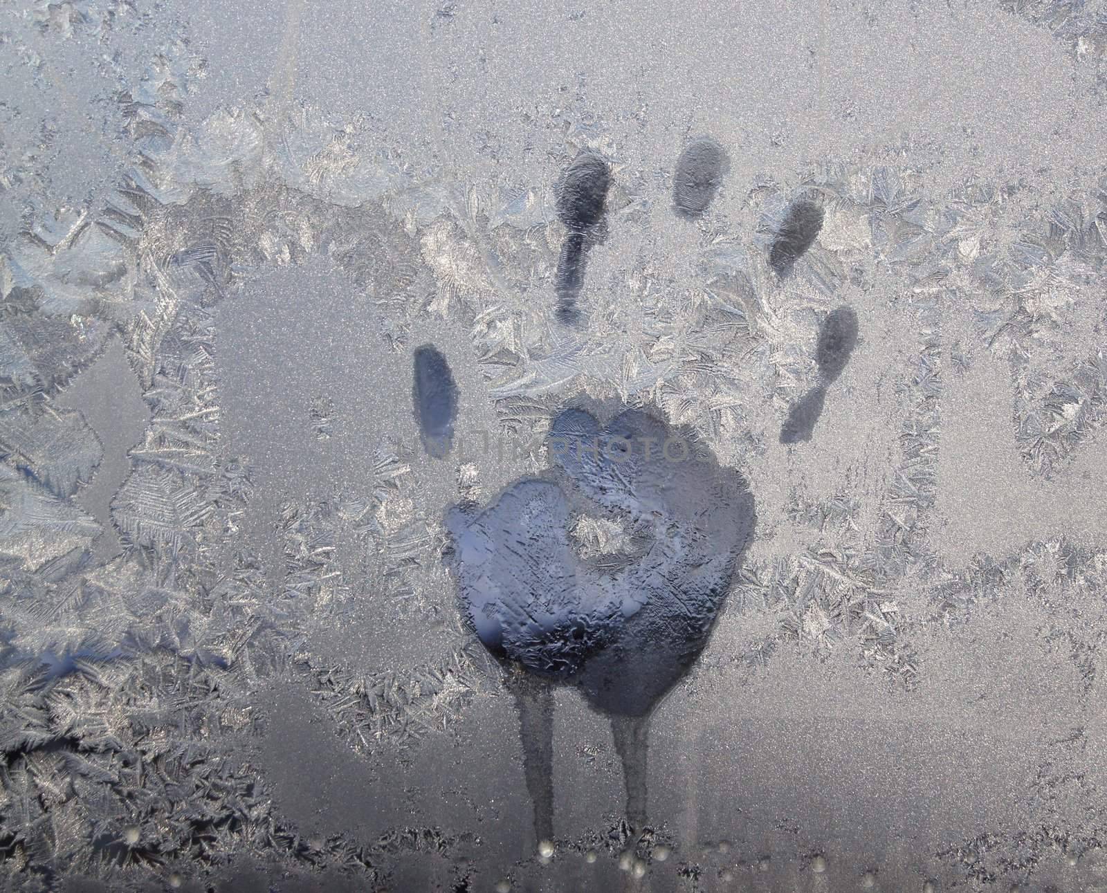 Handprint on ice window, sign desires spring