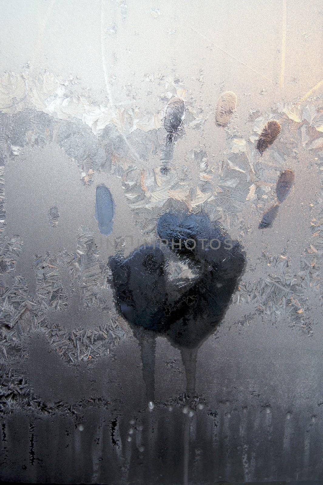 Handprint on ice window, sign desires spring