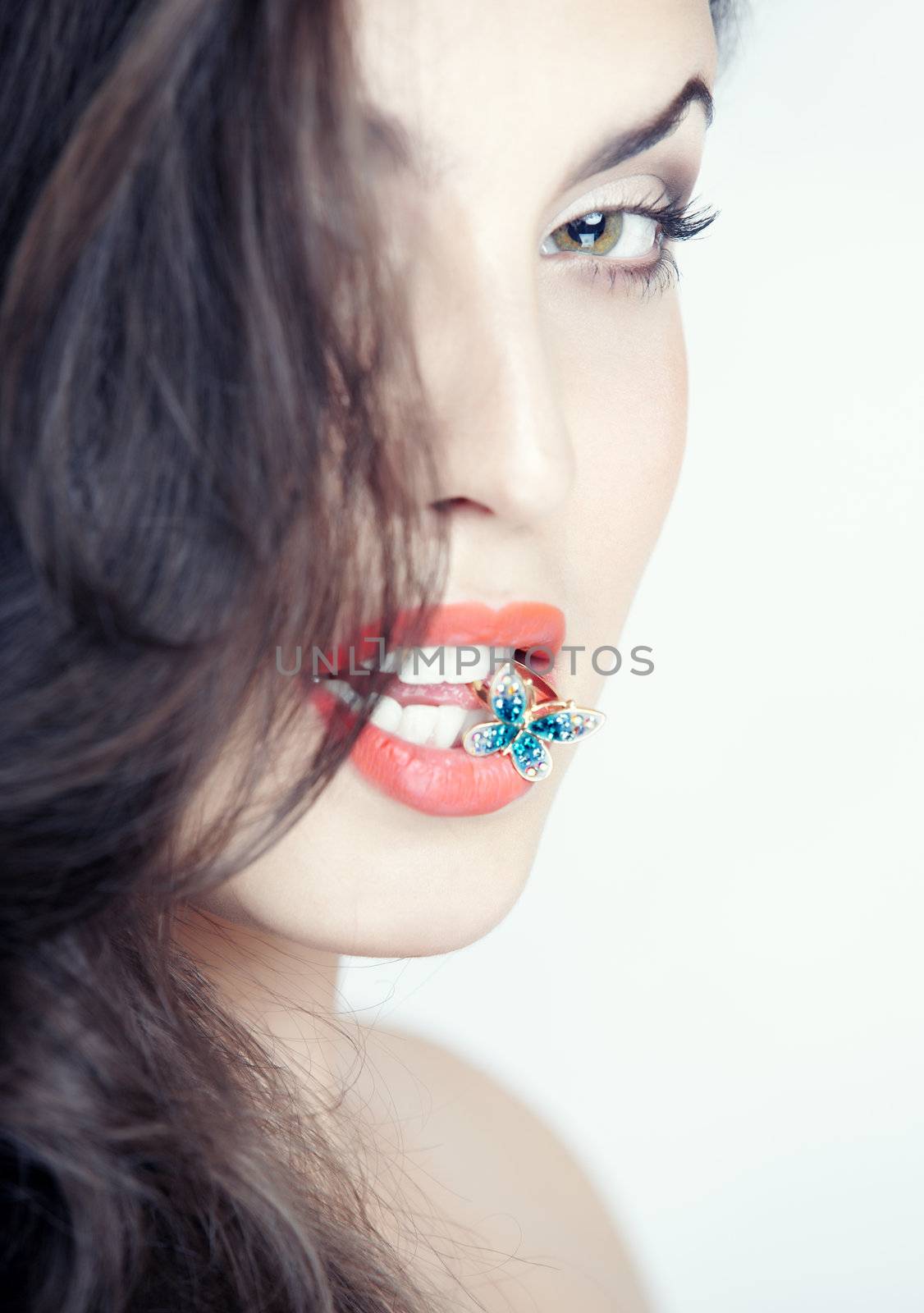 Beautiful lady with golden ring in her mouth