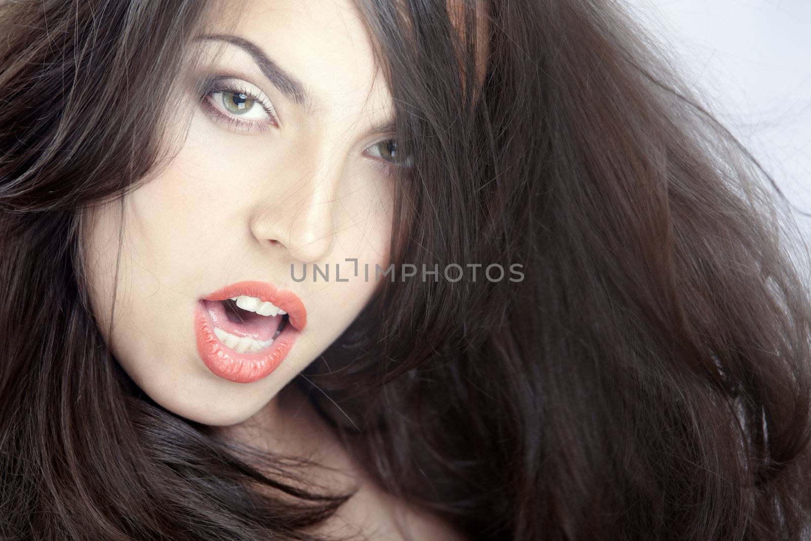 Beautiful lady with perfect makeup and blown hairs. Studio photo
