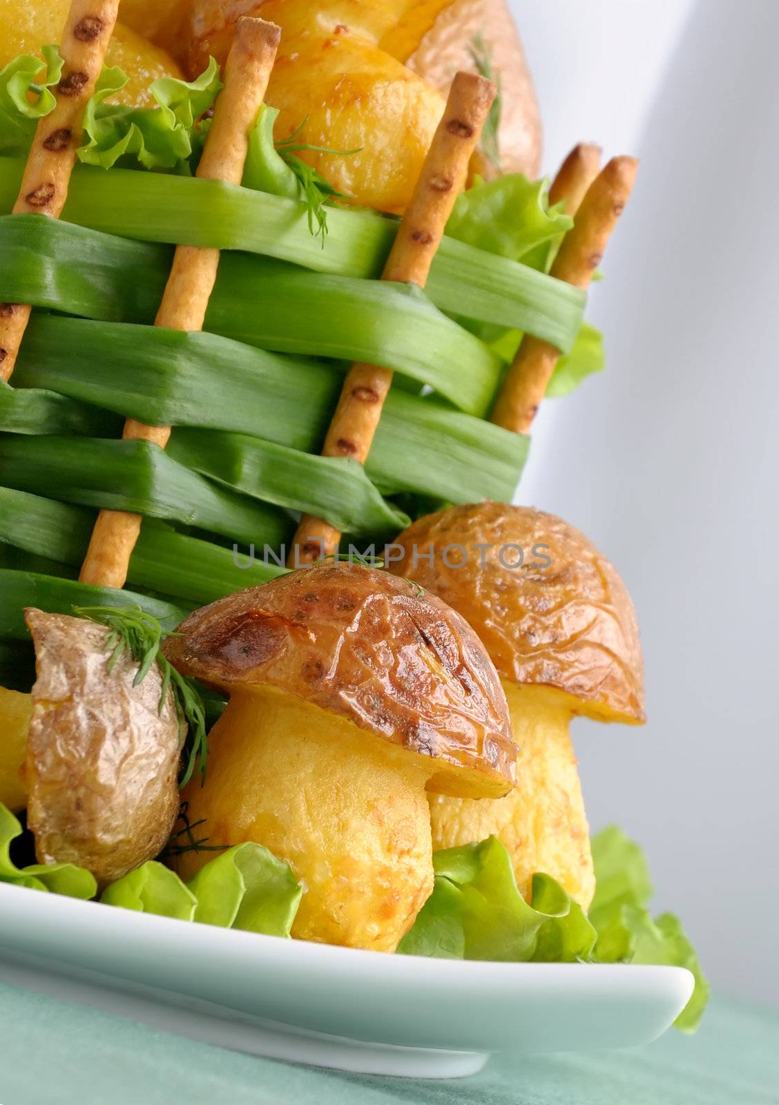 Mushrooms of potatoes (French fries) in a basket of green onions