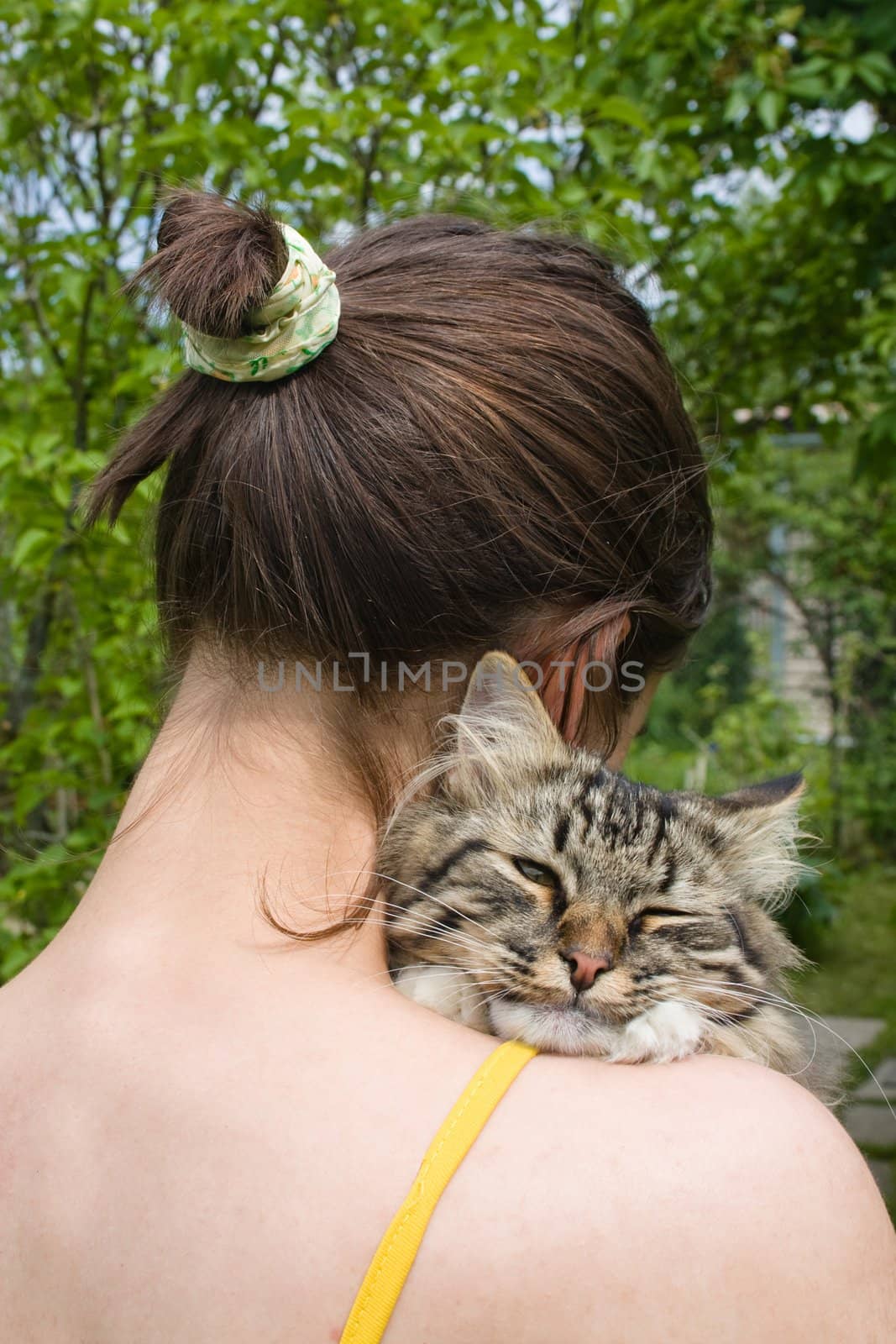 Girl teenager holding and hugging her cat