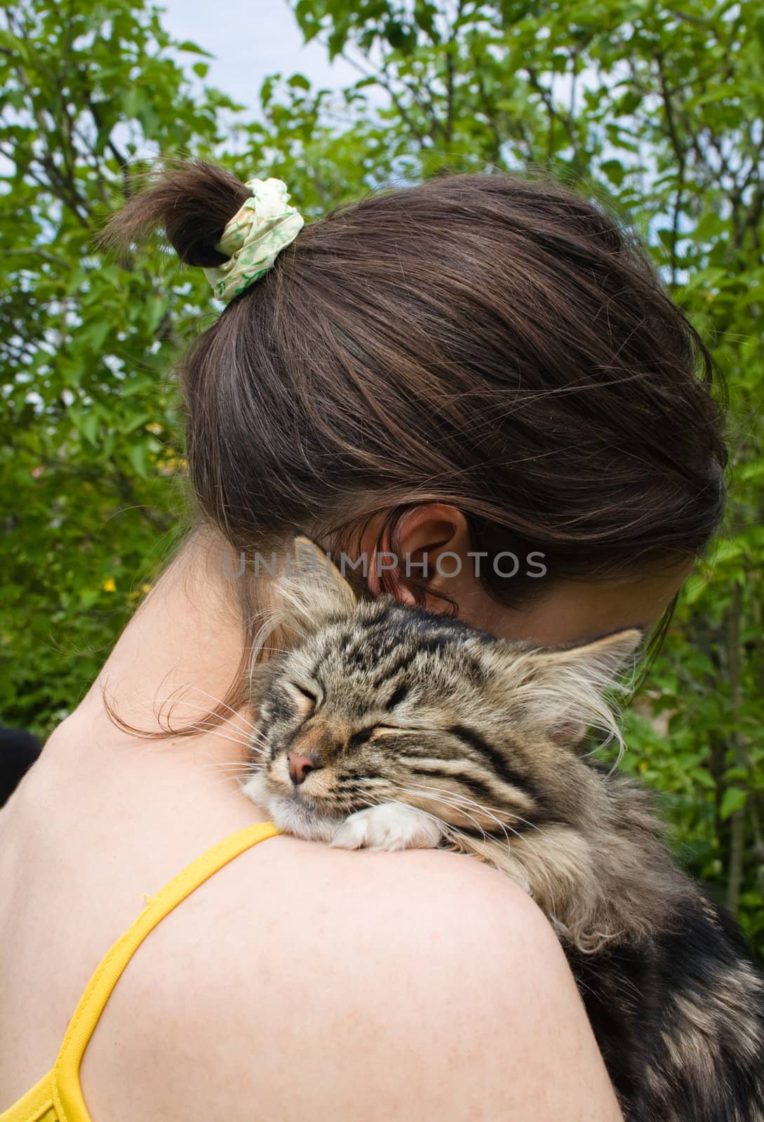 Girl teenager holding and hugging her cat