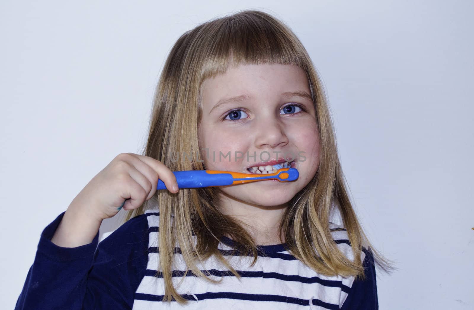 little baby girl is brushing her tooth