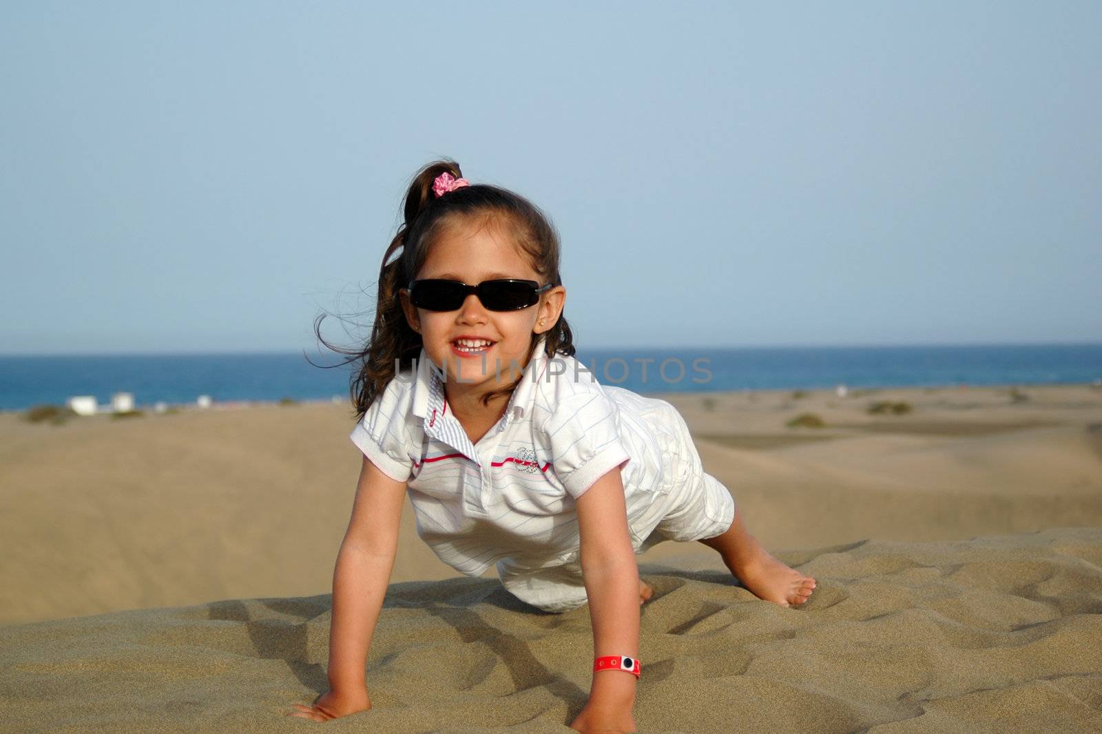 A happy smiling child in a desert