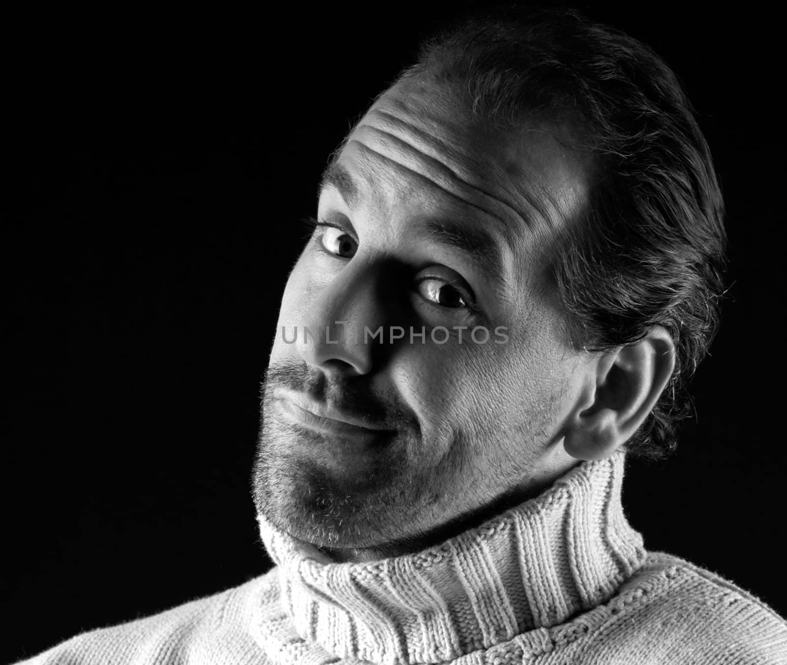 Adult man portrait cheerful wink expression on black and white