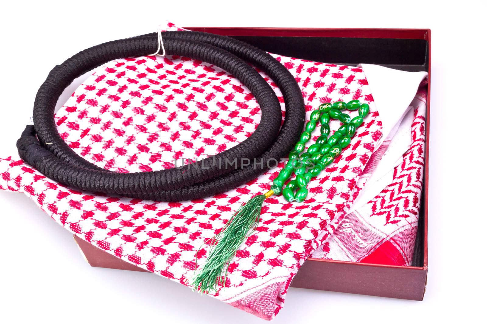 folded muslim hear gear with rosary bead in gift box on white surface