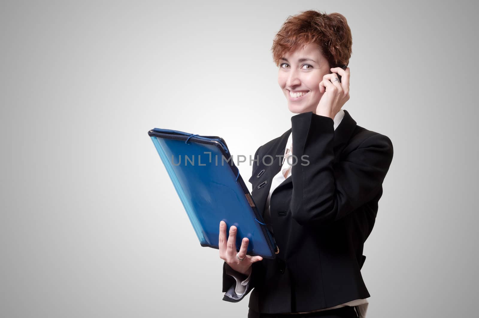 success business woman with briefcase and phone on gray background