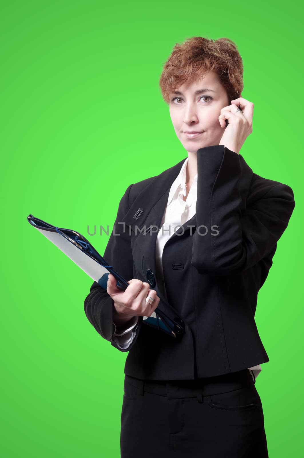 success business woman with briefcase and phone on green background