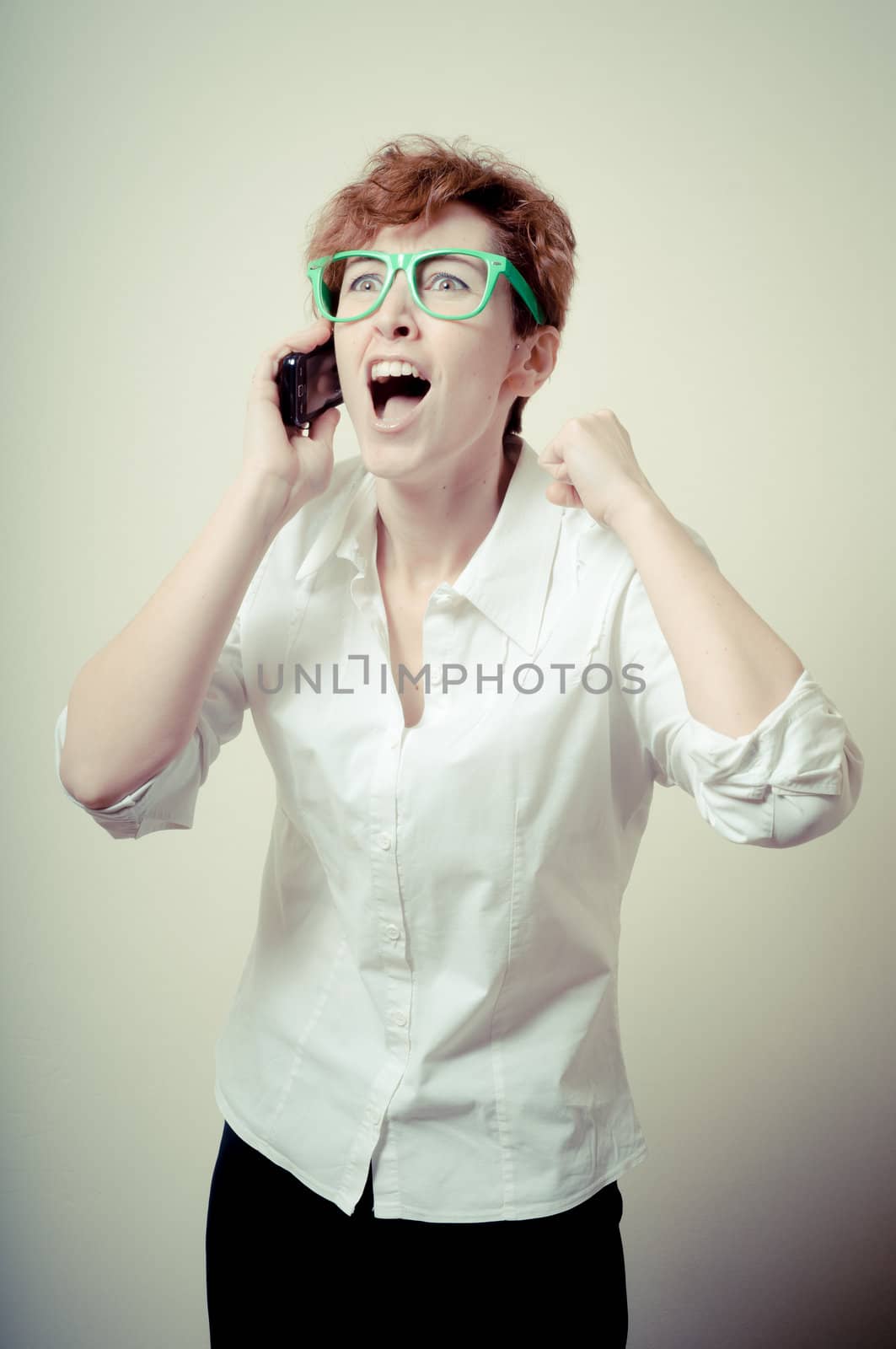 business woman calling on phone on gray background