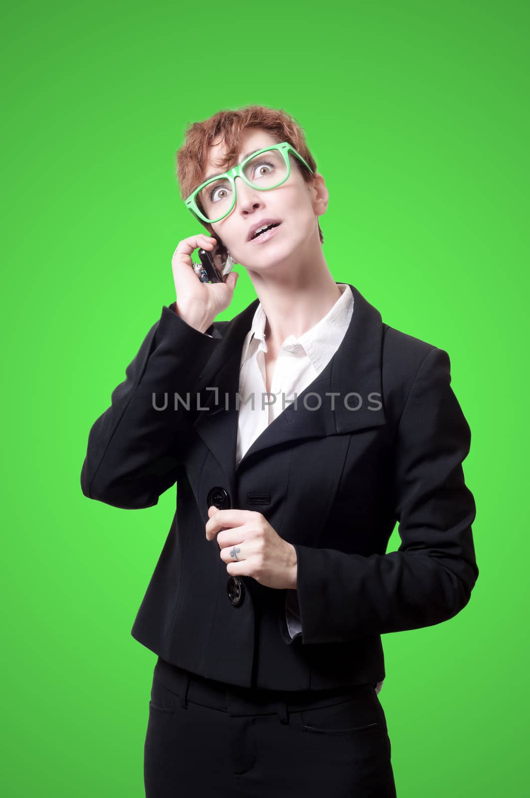 business woman calling on phone on green background