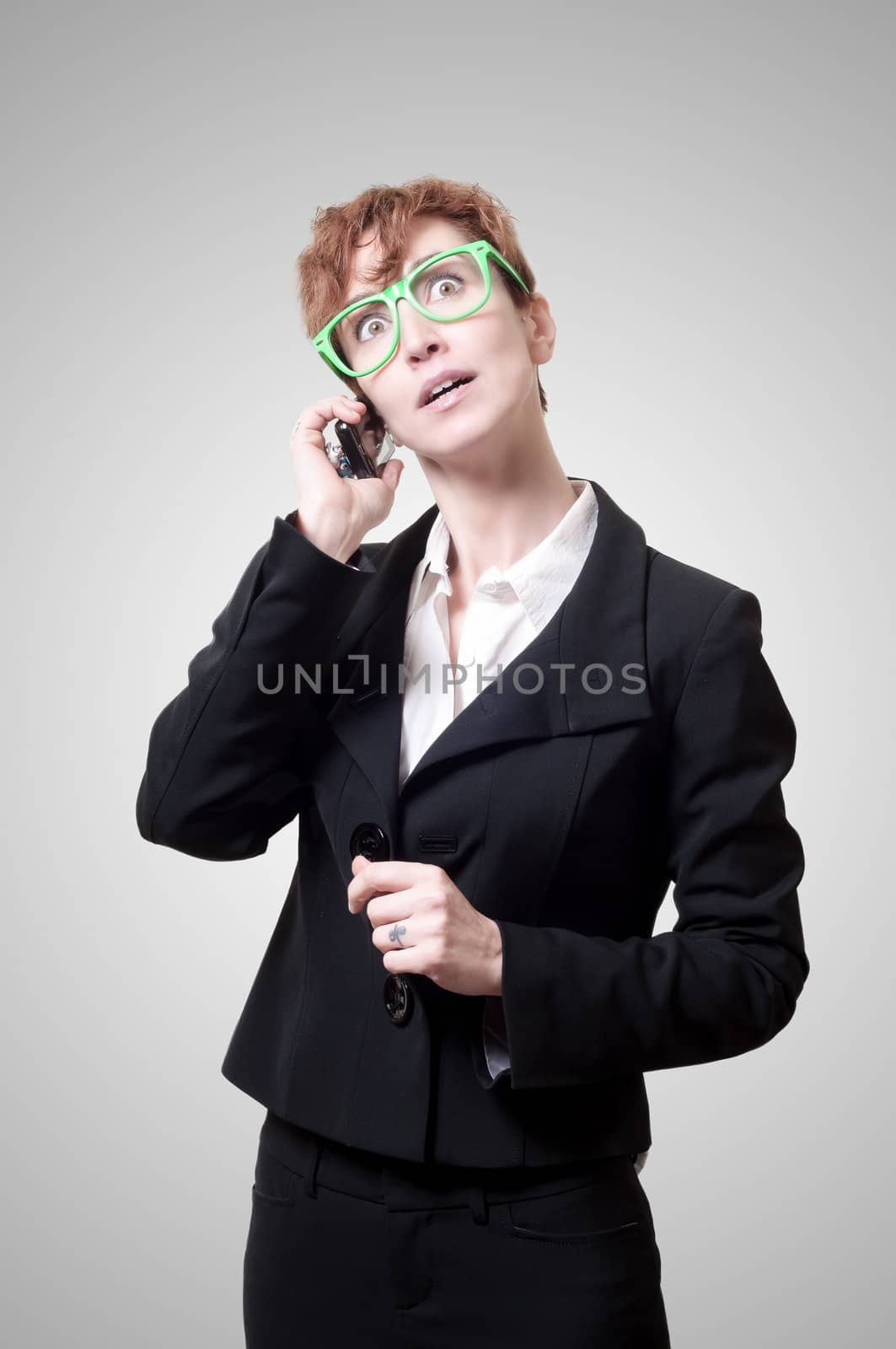 business woman calling on phone on gray background