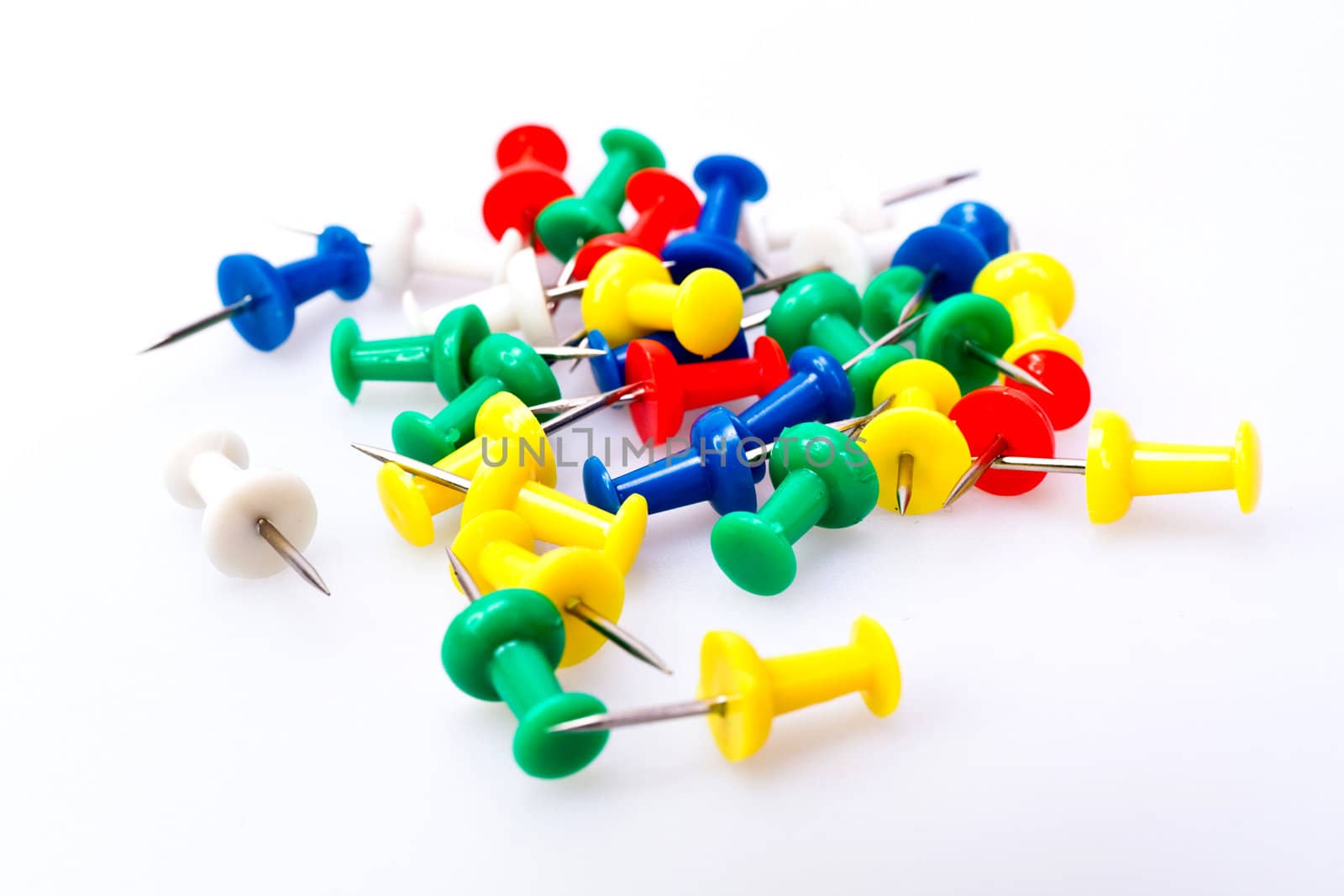 Colorful plastic pushpin on white background
