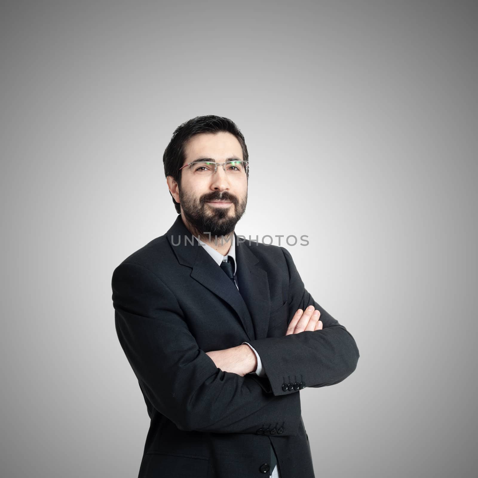 elegant bearded success business man on gray background