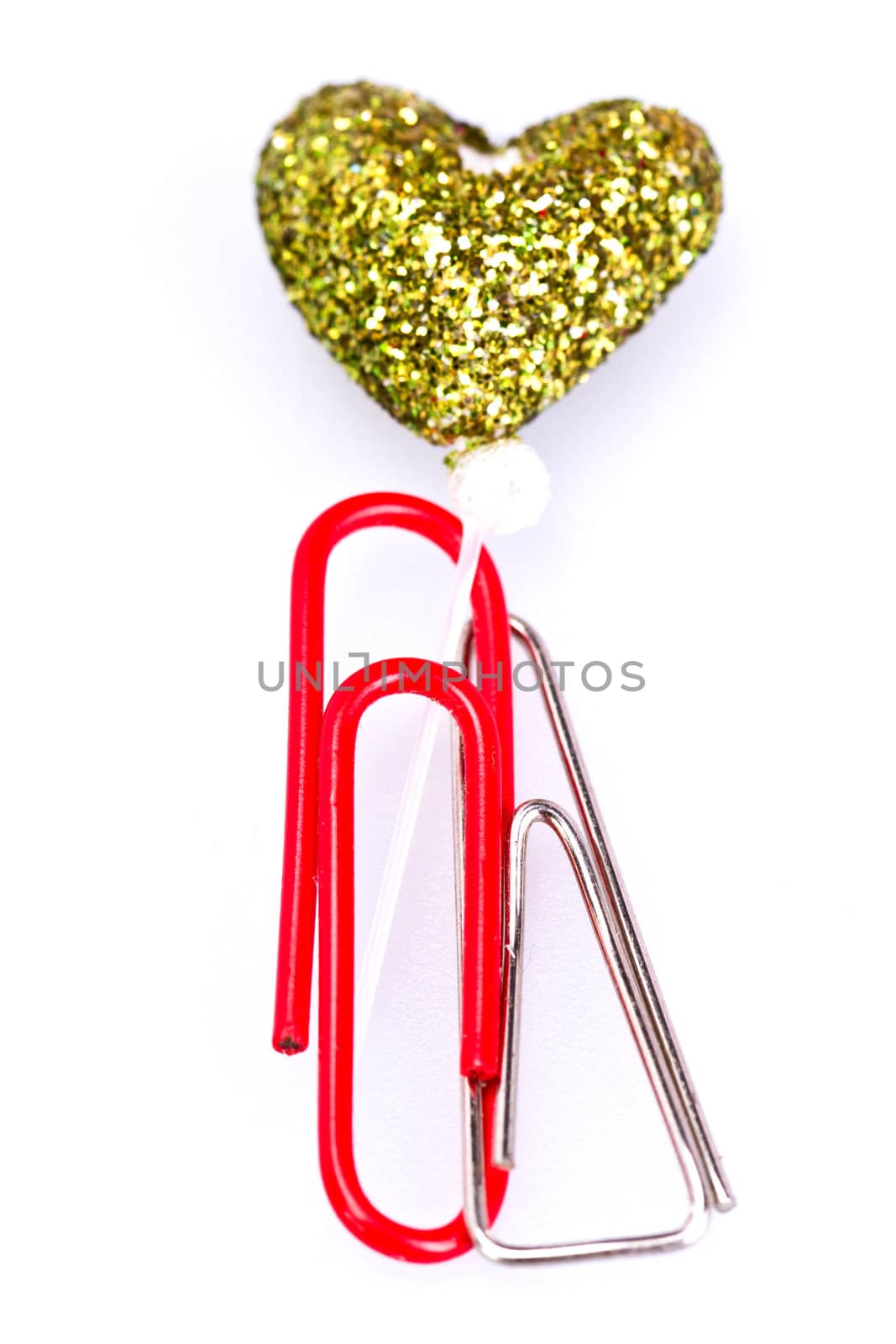 Metal and red plastic paerclip together with love symbol on white background