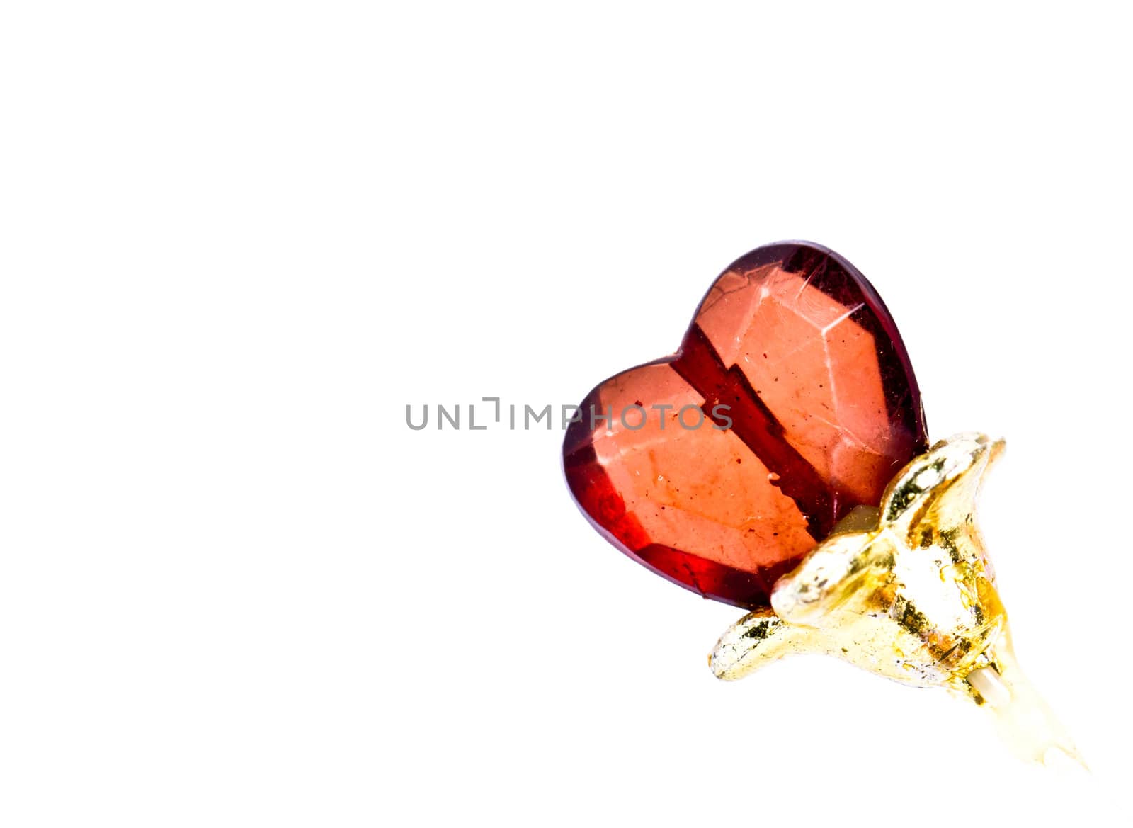 shining stone in the shape of heart against white background