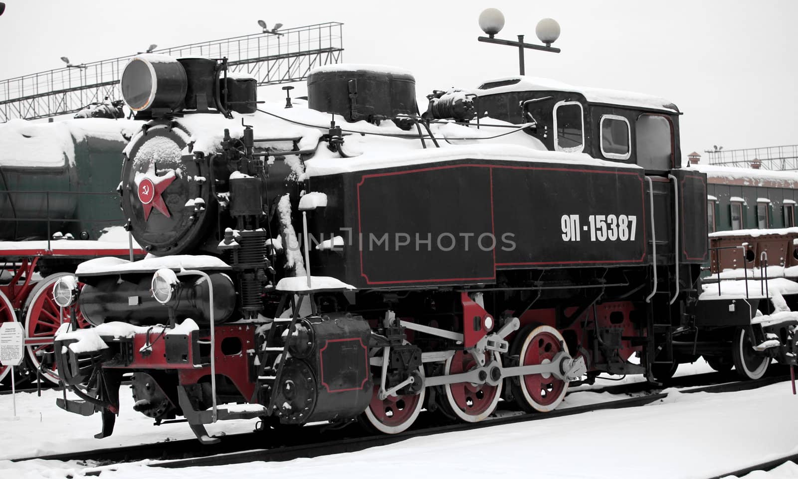old Soviet locomotive at a train station in winter