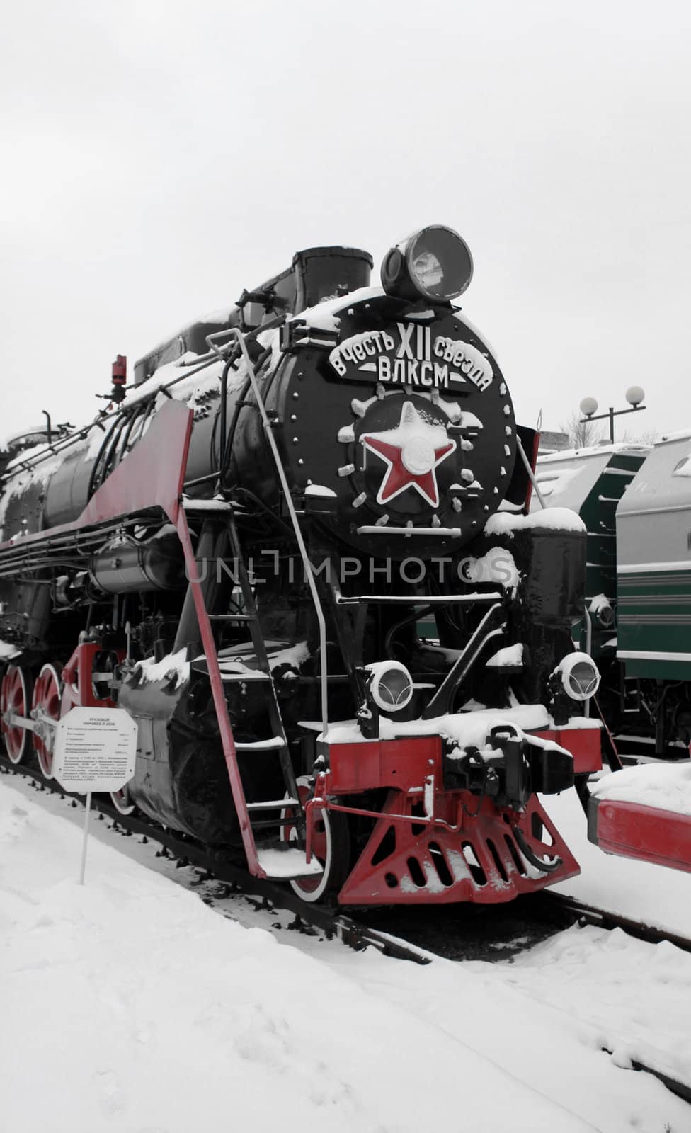 old Soviet locomotive at a train station in winter