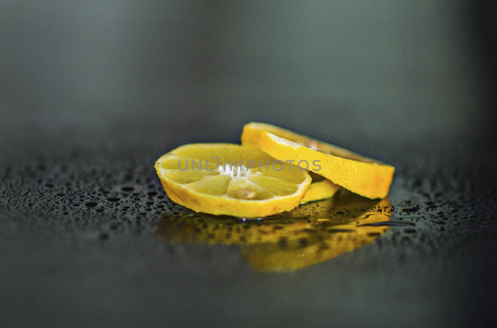 realy fresh lemon slices in drops of water
