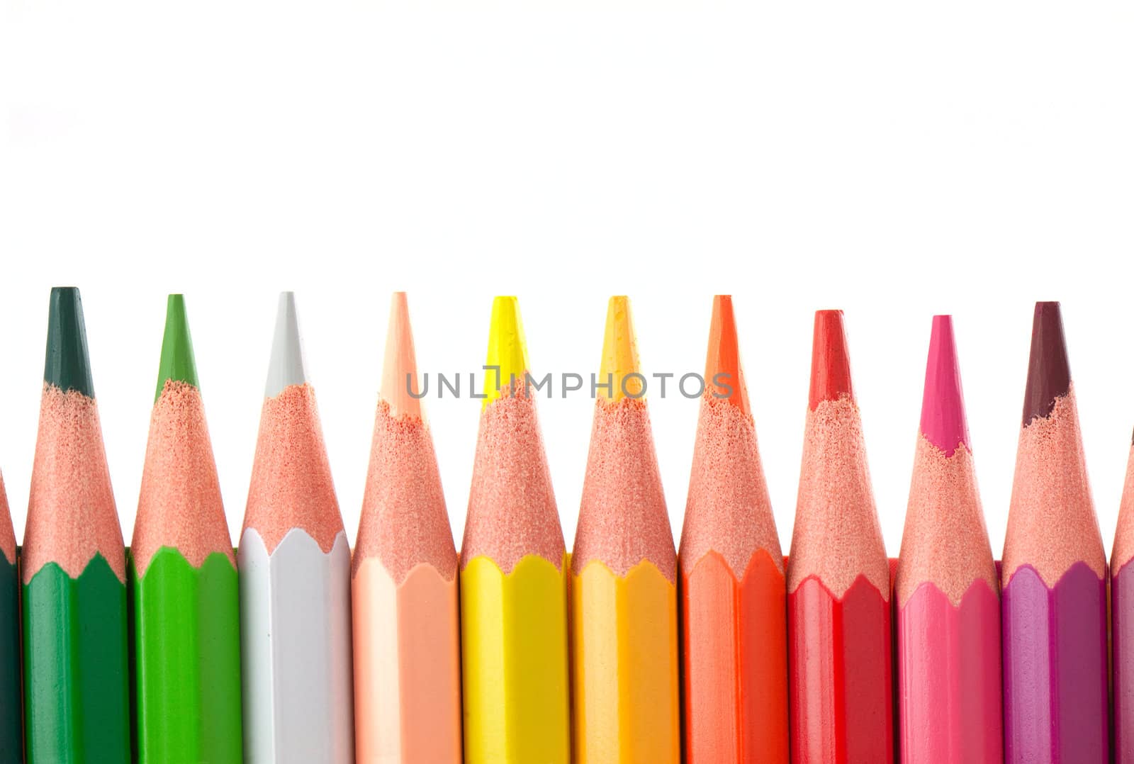 Row of color pencils isolated on white