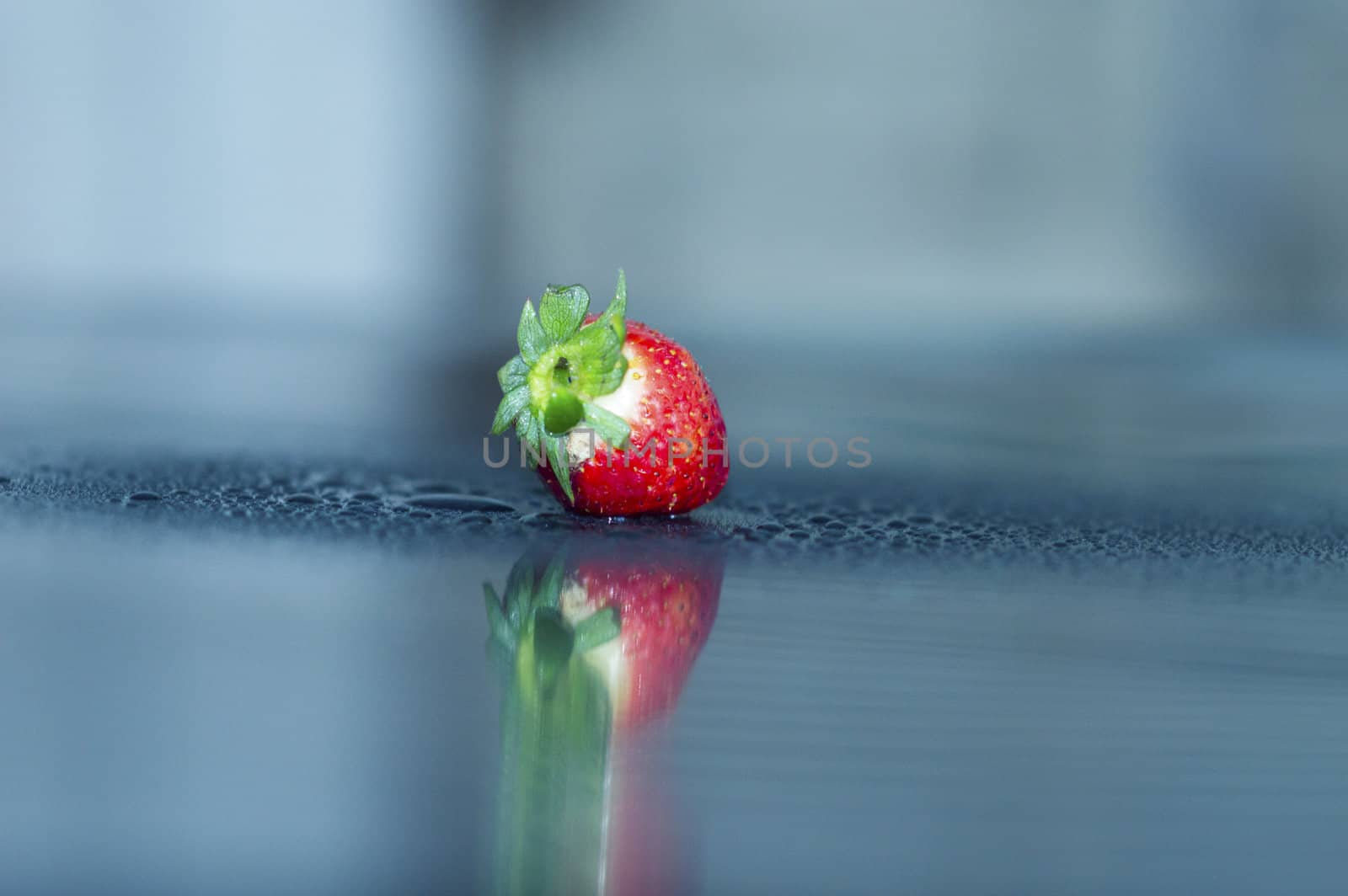fresh strawberry in drop of water