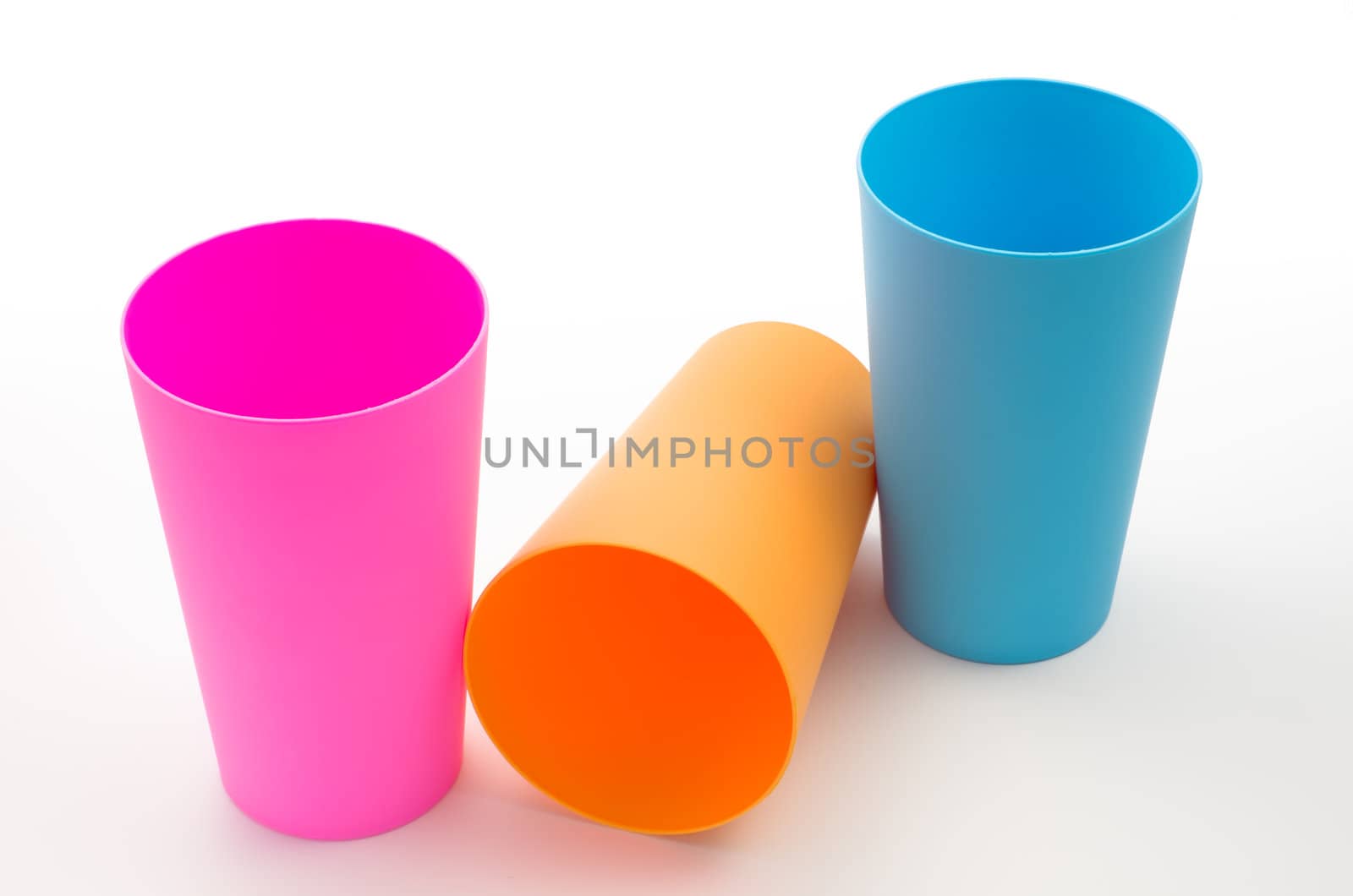 Three color plastic cup on white table