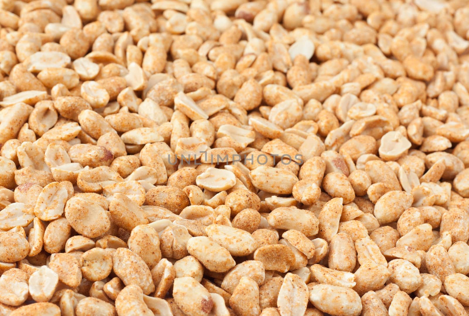 Background of roasted peanuts with shallow depth of field.