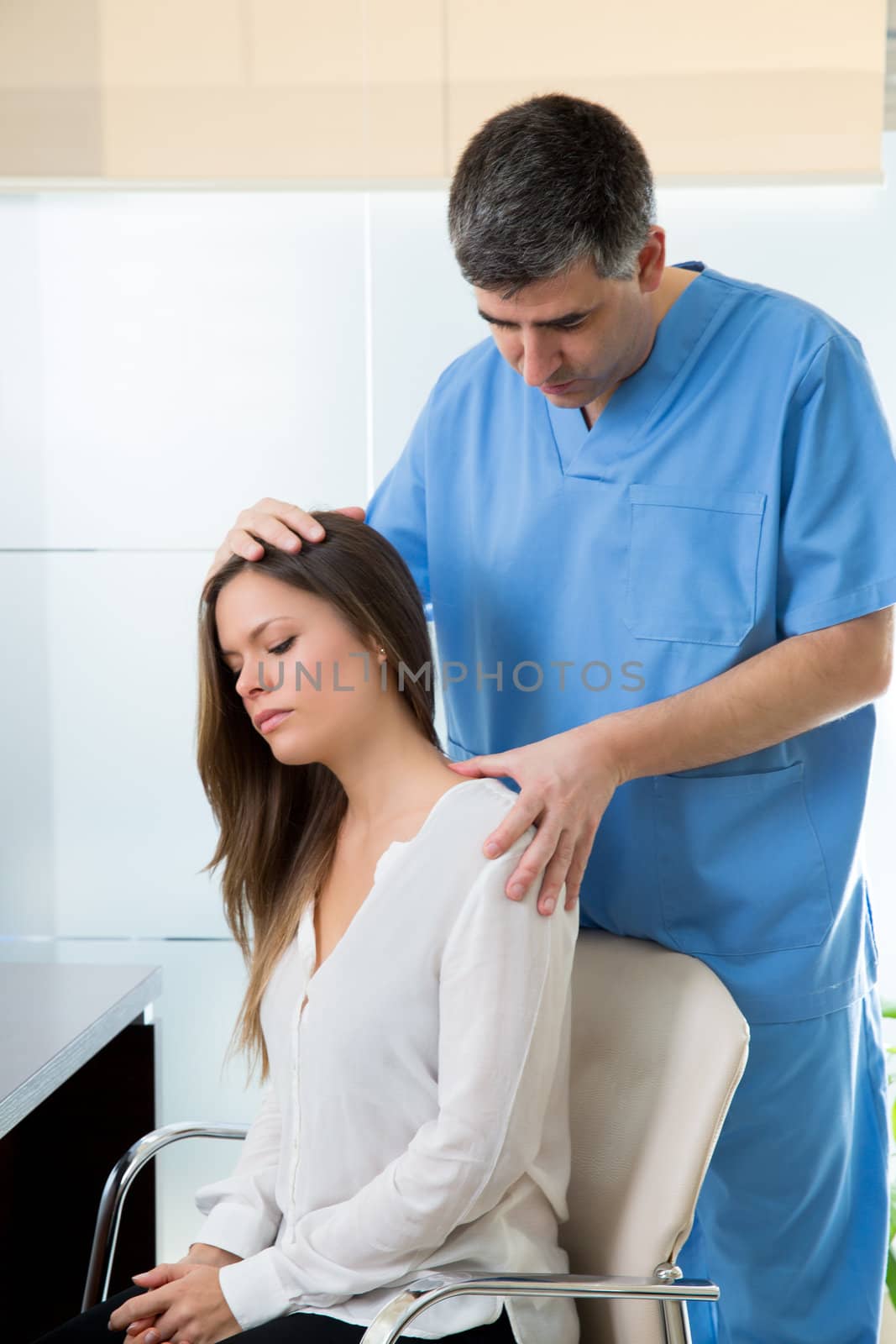 physiotherapist doing myofascial therapy on woman patient in hospital