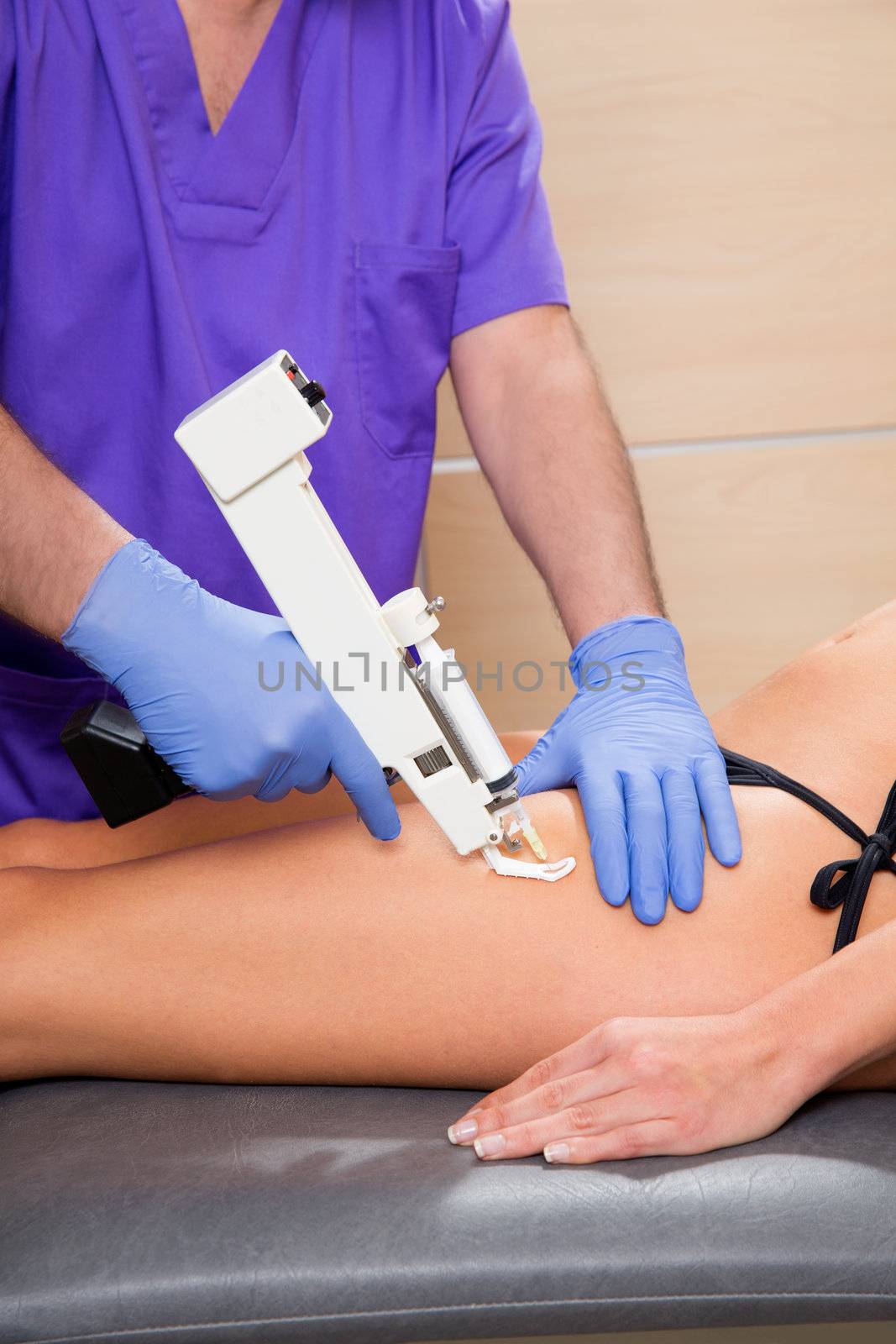 mesotherapy gun therapy for cellulite doctor with woman by lunamarina