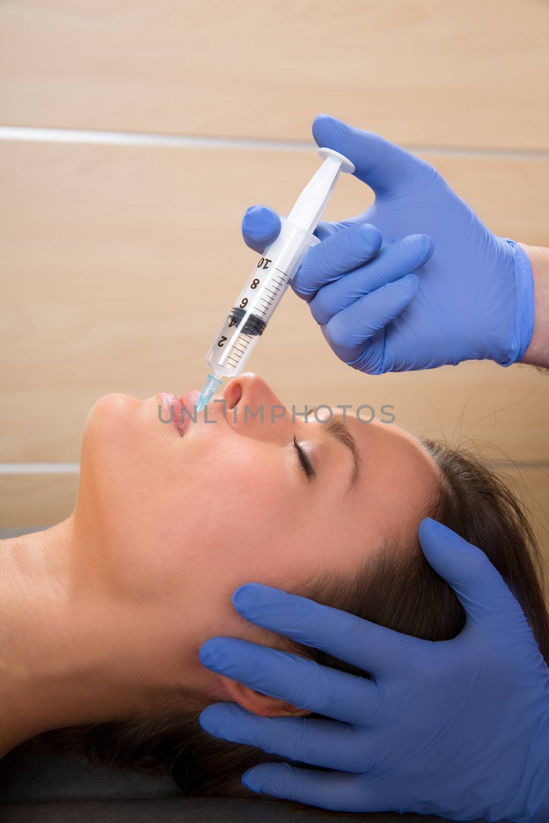 Anti aging facial mesotherapy syringe on woman face by lunamarina