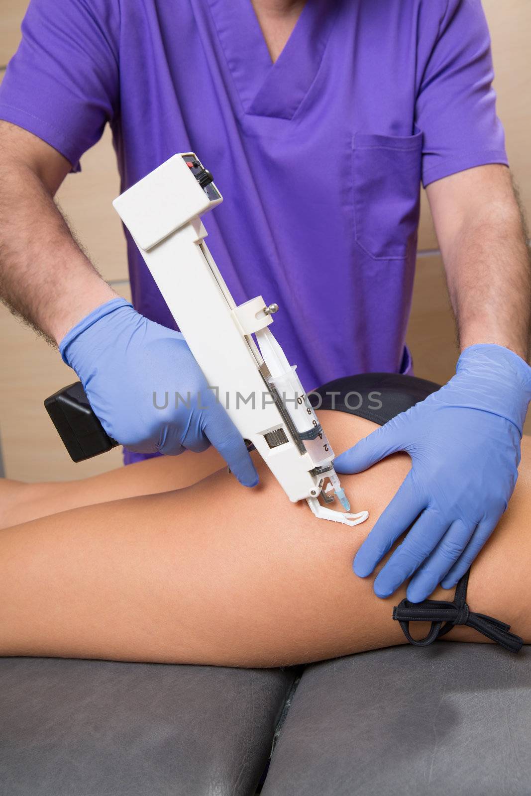 mesotherapy gun therapy for cellulite doctor with woman by lunamarina