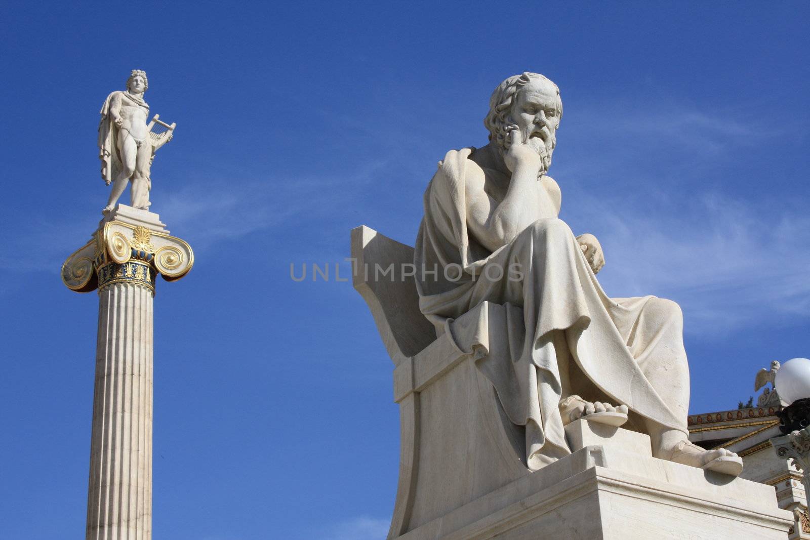 Neoclassical statues of Socrates (Greek ancient philosopher) and Apollo (god of  the sun, medicine and the arts) in front of the Academy of Athens, Greece.