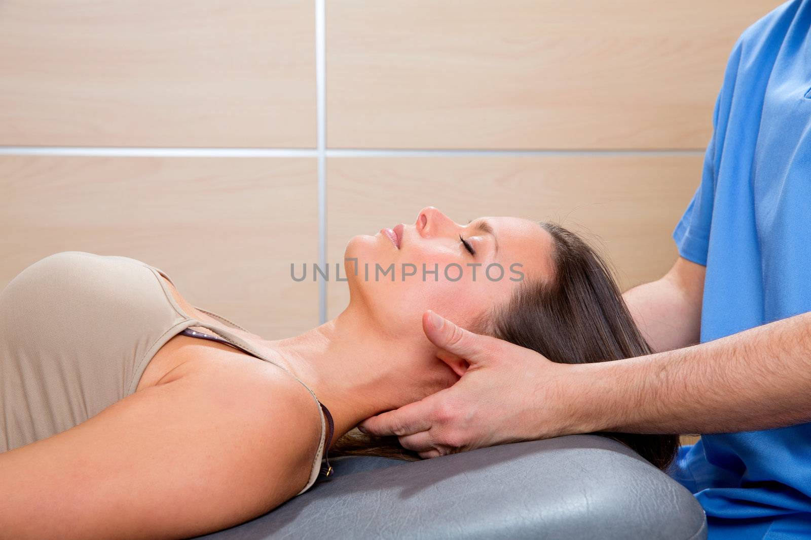suboccipital massage therapy to woman with doctor hands by lunamarina