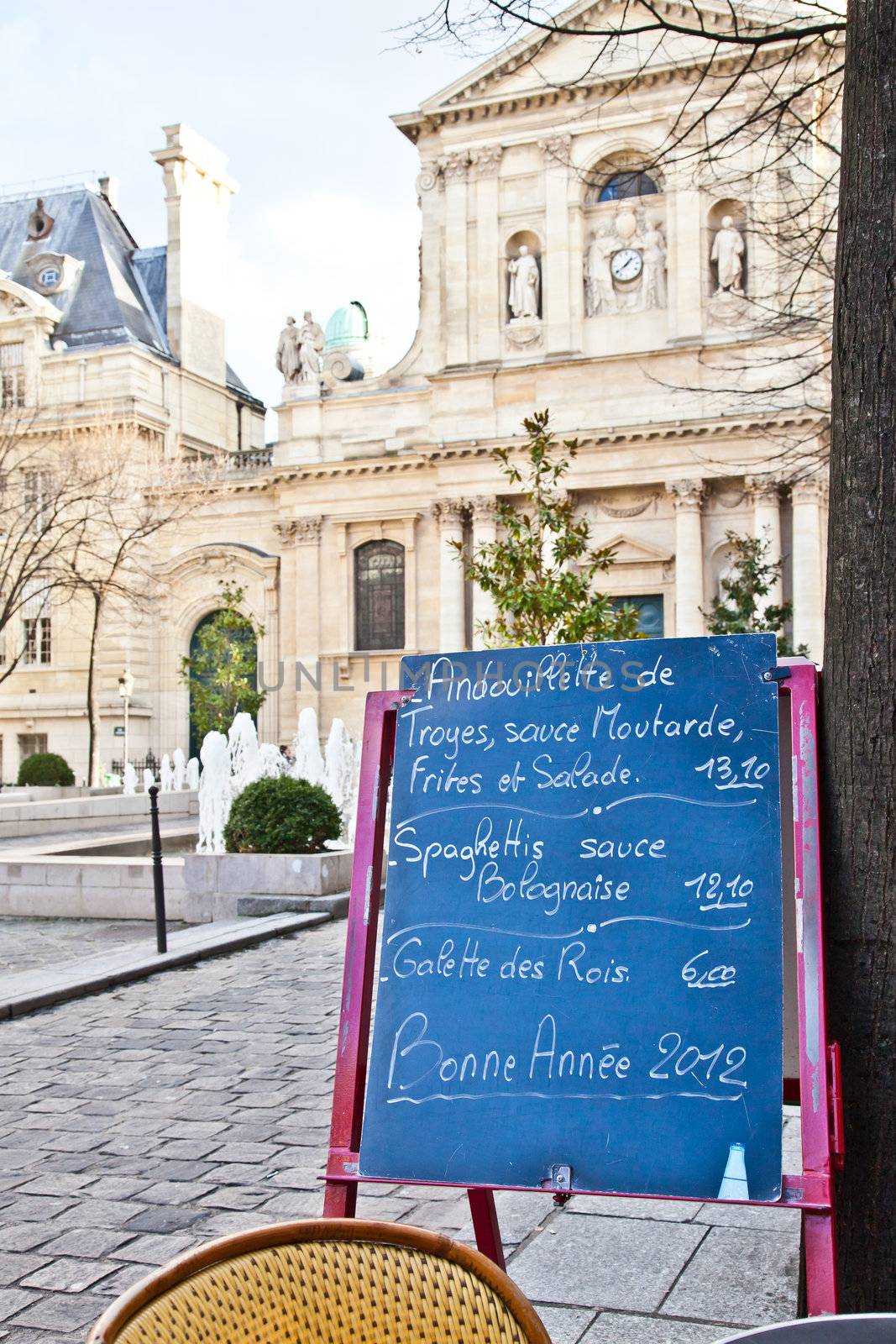 Black board with a menu restaurant in a tipical traditional square in Paris