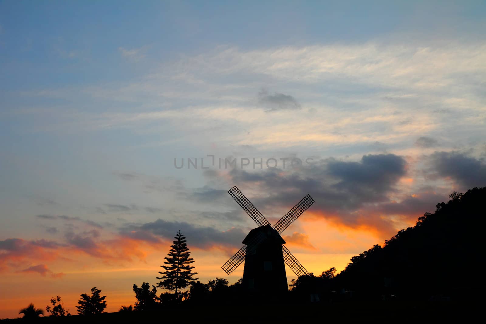 Silhouettes of windmill at sunset, at Thailand 