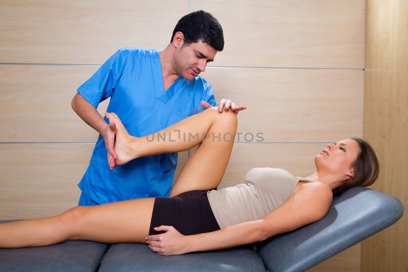 hip mobilization therapy by physiotherapist in hospital to beautiful woman