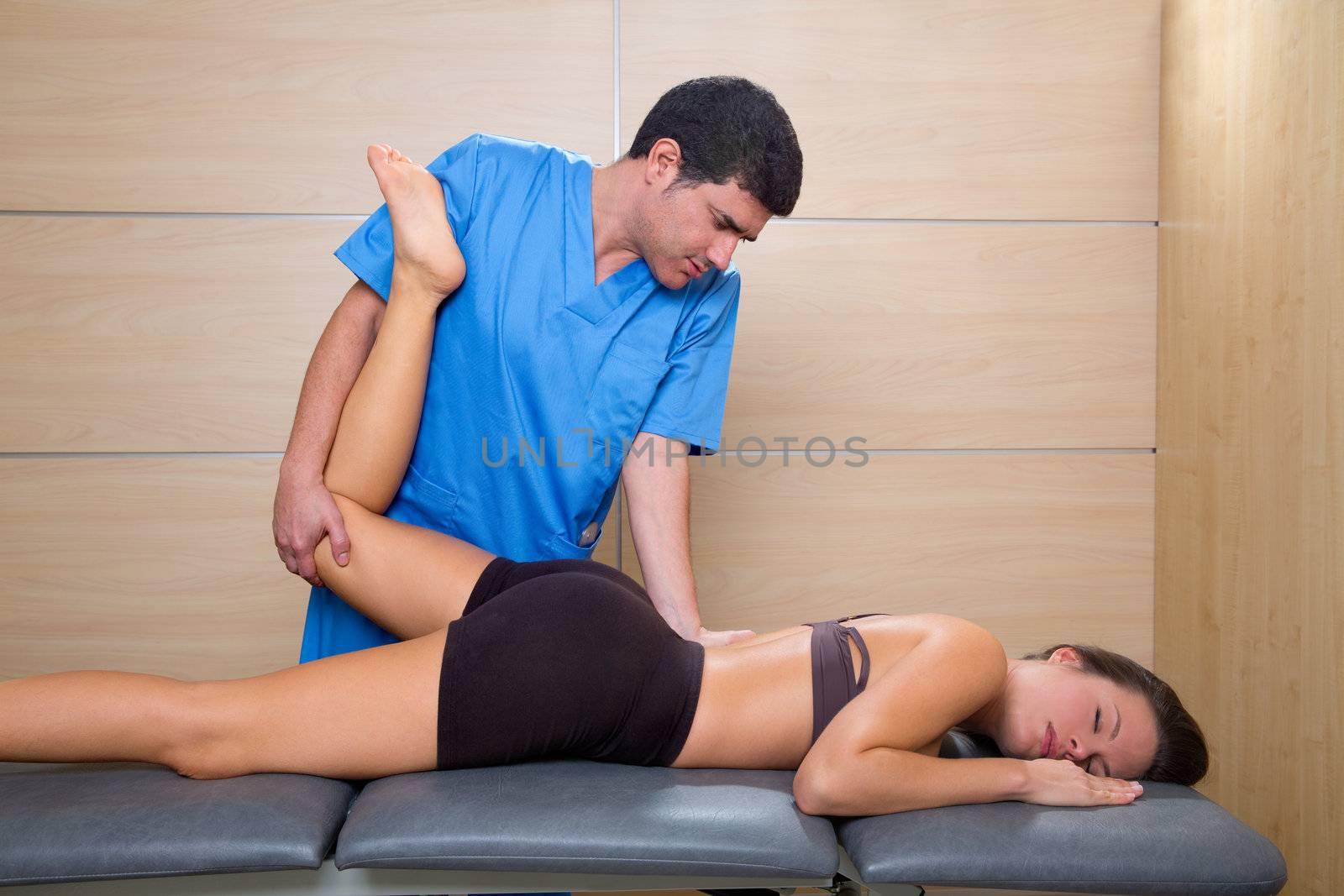 muscle power therapy on woman leg knee by therapist