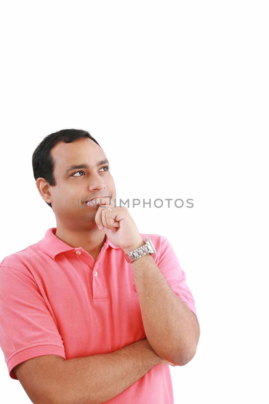 handsome hispanic man looking upwards at copyspace thinking