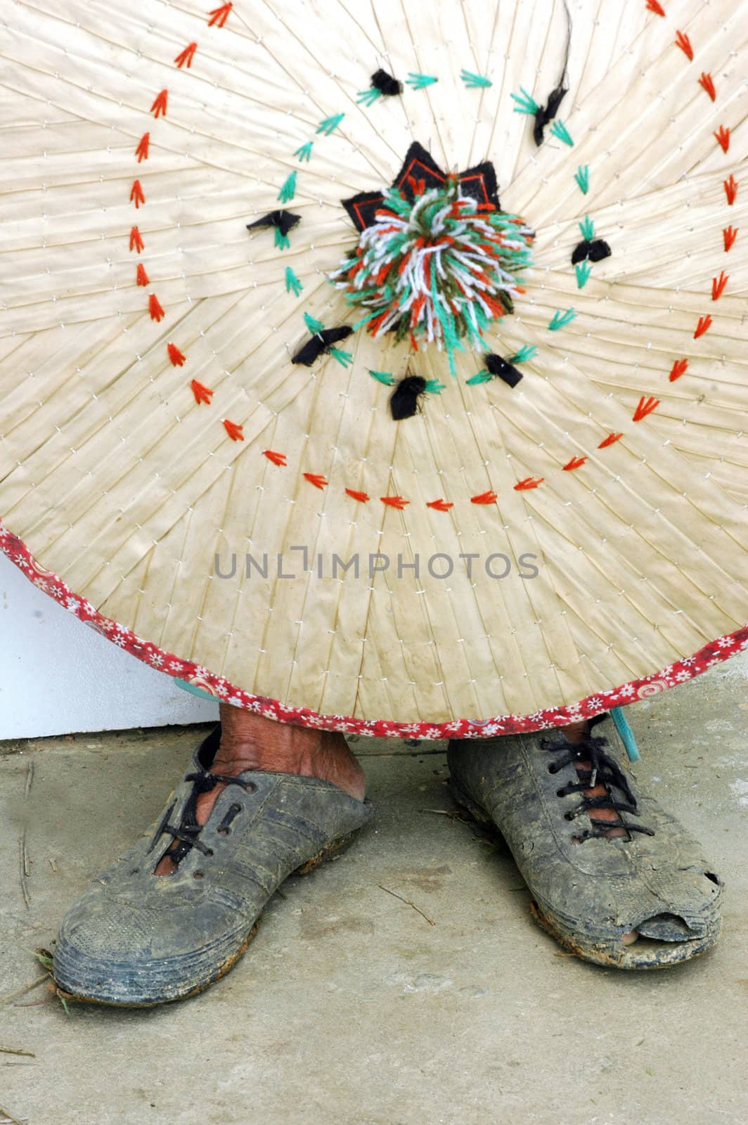 traditional woven with an old woman wearing shoes that are worn