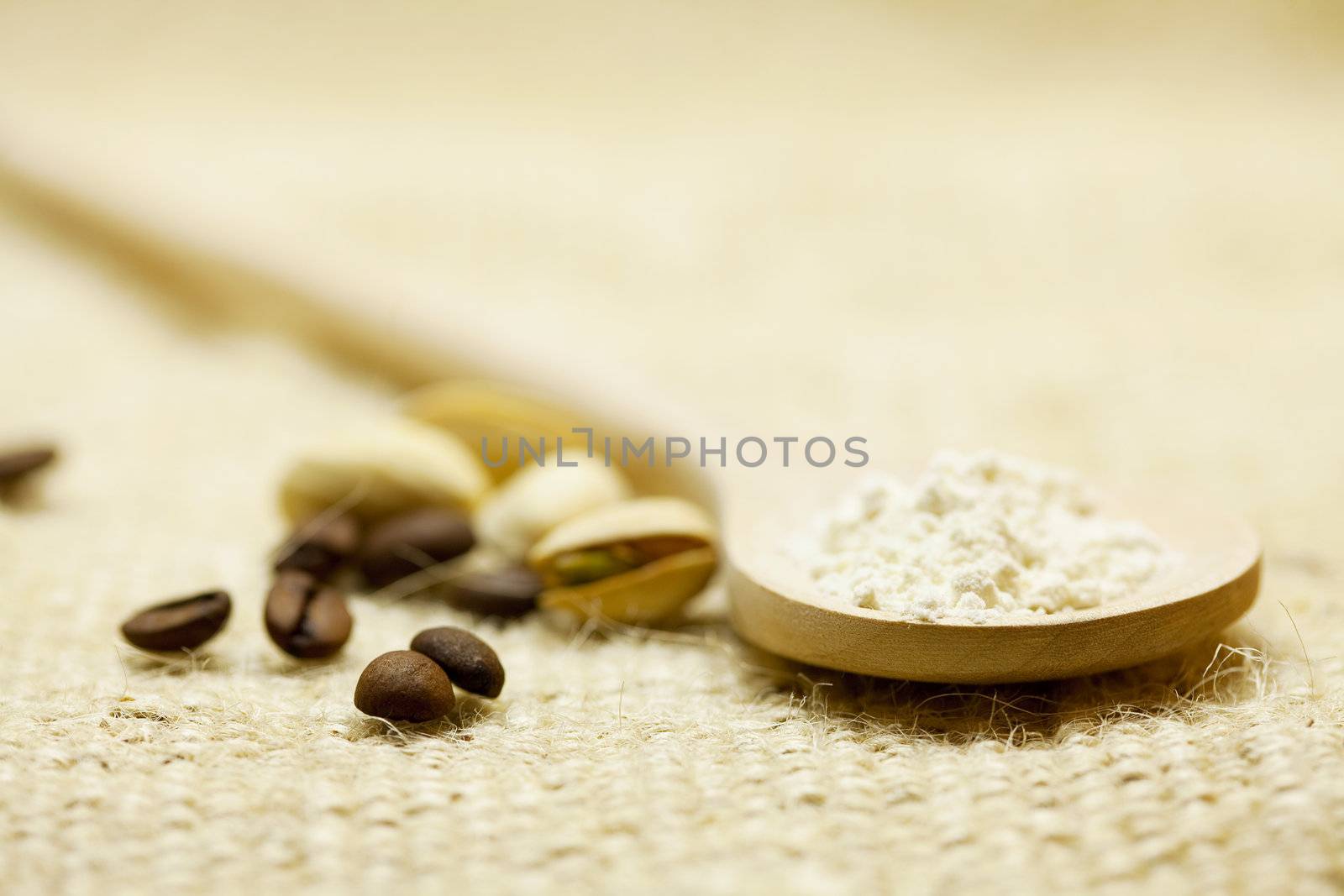 wooden spoon and pistachios on linen fabric