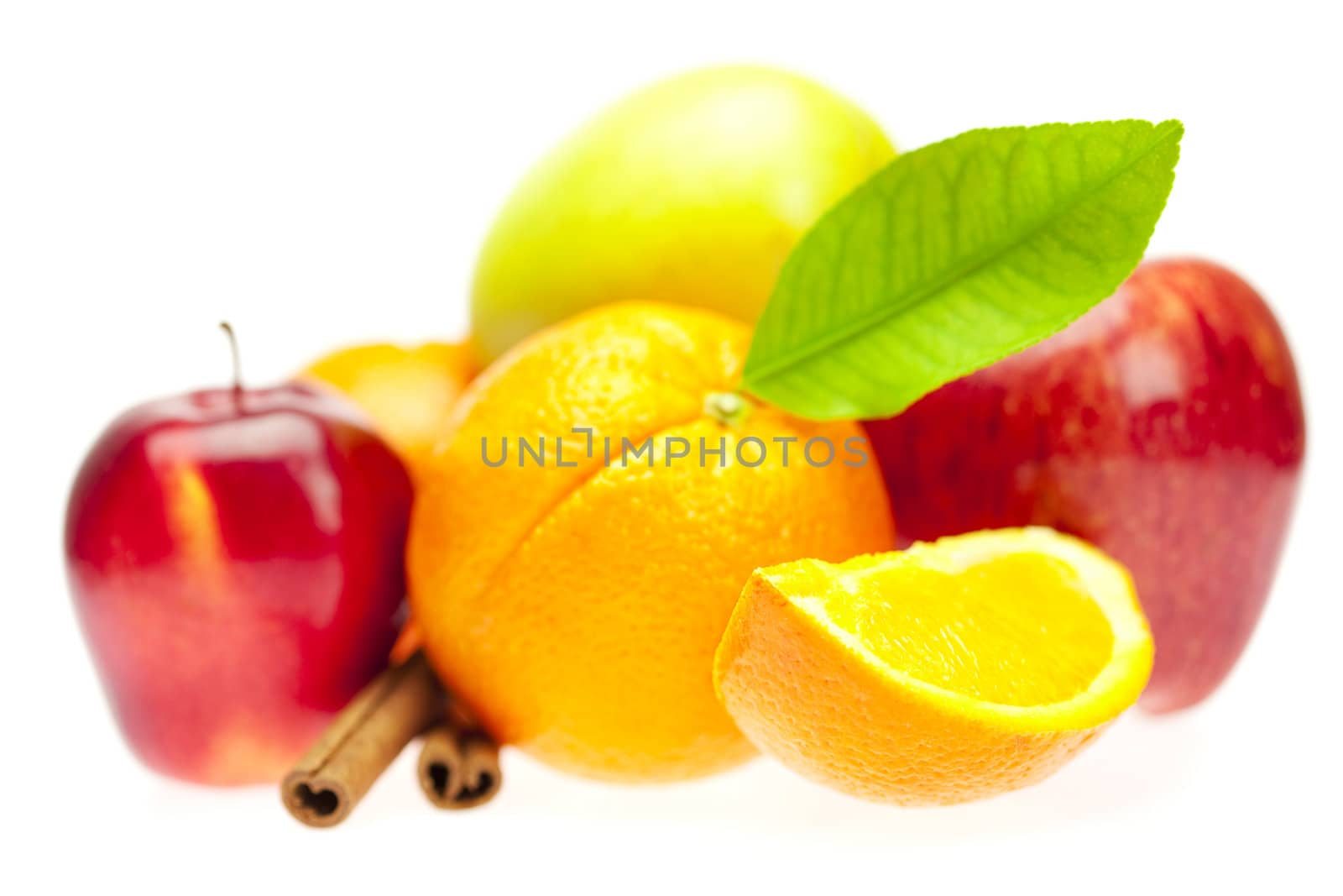 oranges, cinnamon sticks and apples isolated on white