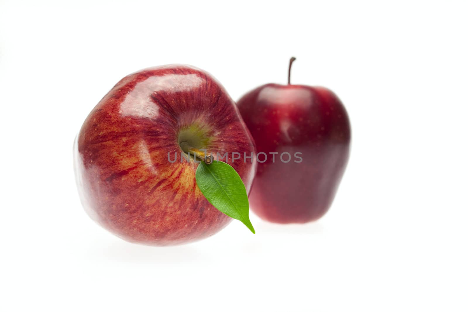 apples with green leaves isolated on white