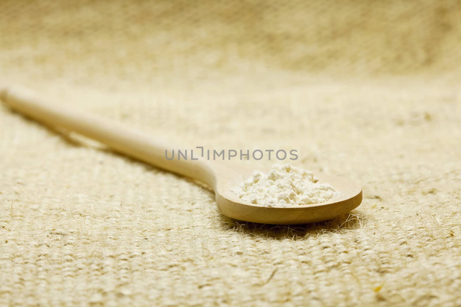 spoon of flour on linen fabric