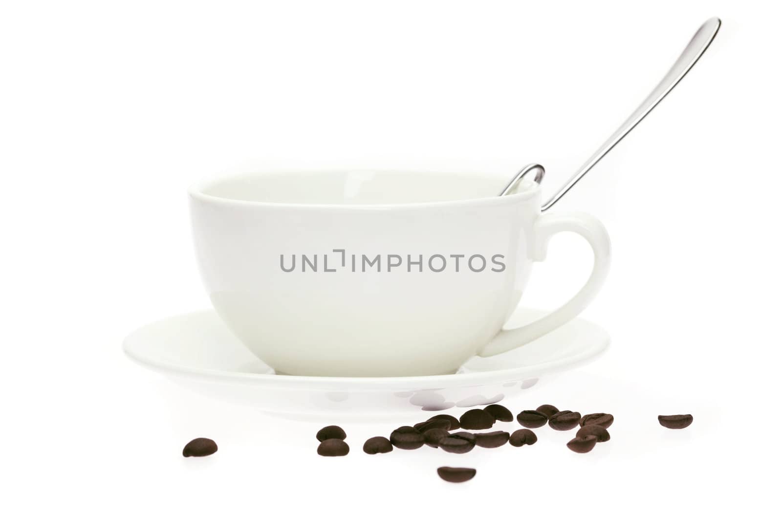 cup and saucer and coffee beans isolated on white