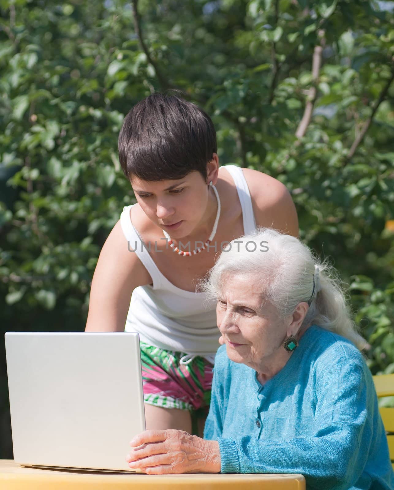 Grandmother and granddaughter with laptop by nikolpetr