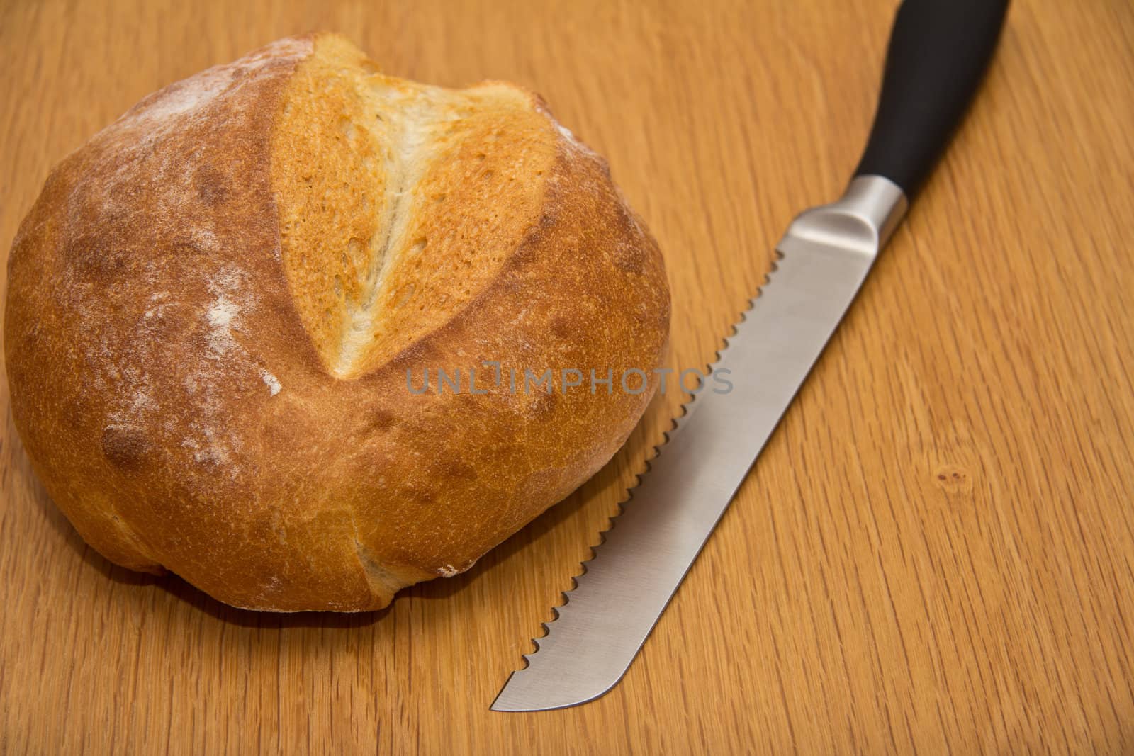 A loaf of fresh bread and a knife